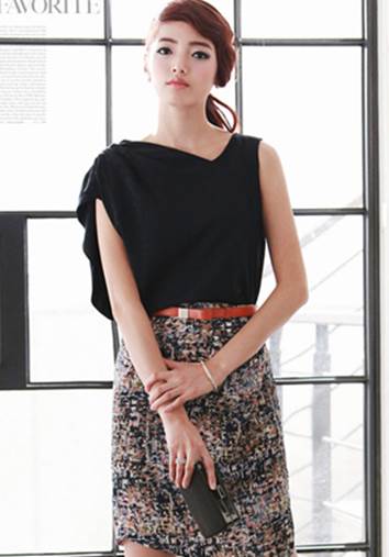 An orange belt creates elegant point for patterning skirt.