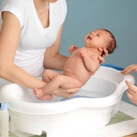 Bathing baby is funny time for both mother and baby.