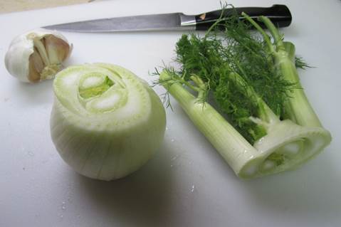 2. Cut the base and tops off the fennel bulbs and remove the tough outer layer. 
