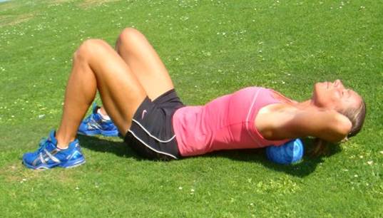 Description: Lie on the floor with your knees bent and place a tennis ball on the affected area close to your spine.