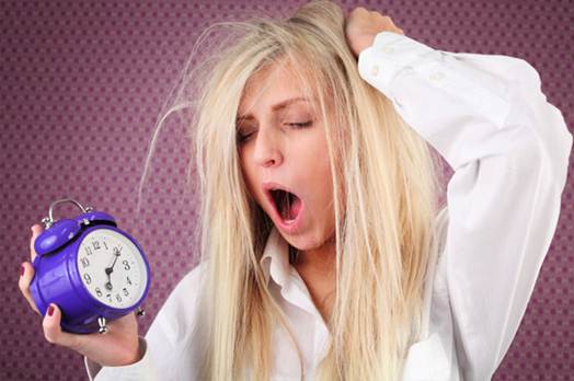 Description:  Tired woman with alarm clock