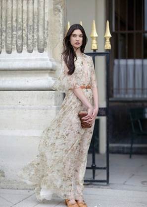 The girl is in maxi with flower pattern,floating chiffon material, and feminine pastel tone as if she has just come out from fairy tales.